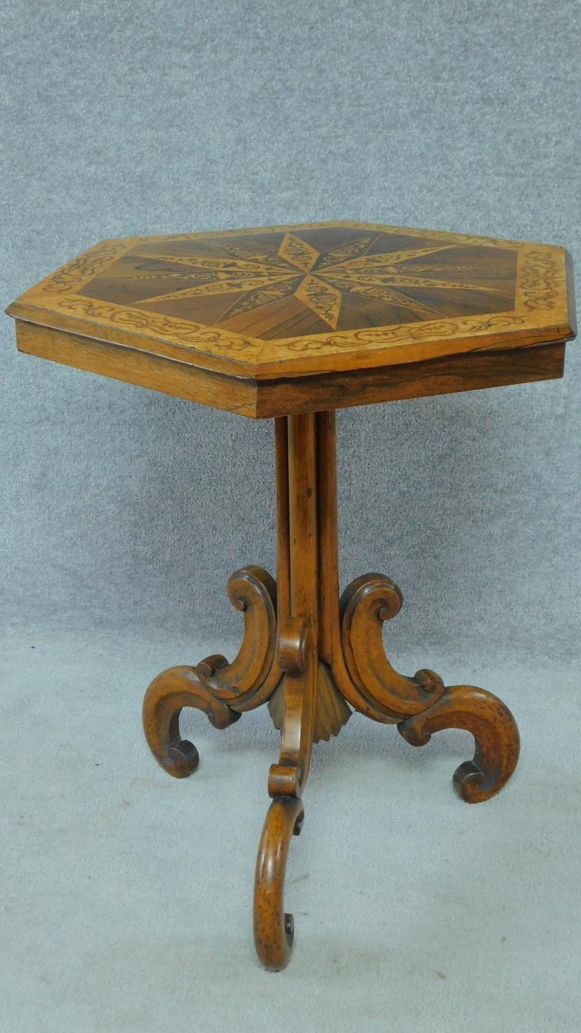 A mid Victorian bird's eye maple and rosewood centre table with profuse Arabesque inlay with tilt