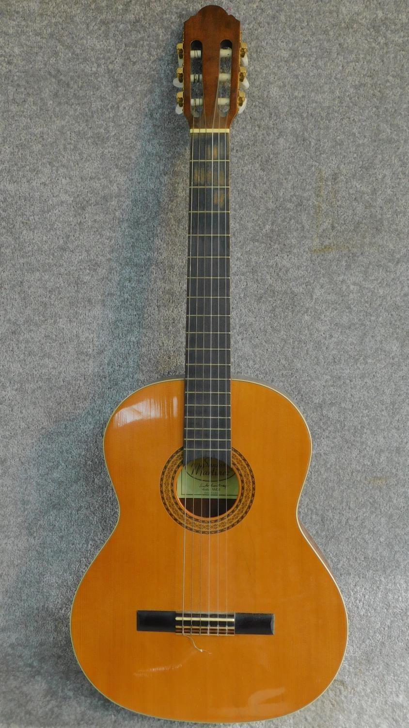 A vintage acoustic guitar by Santos Martinez. Model SM20. H.99cm