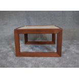 A mid 20th century teak coffee table with inset tiled top. H. 40 x 65cm