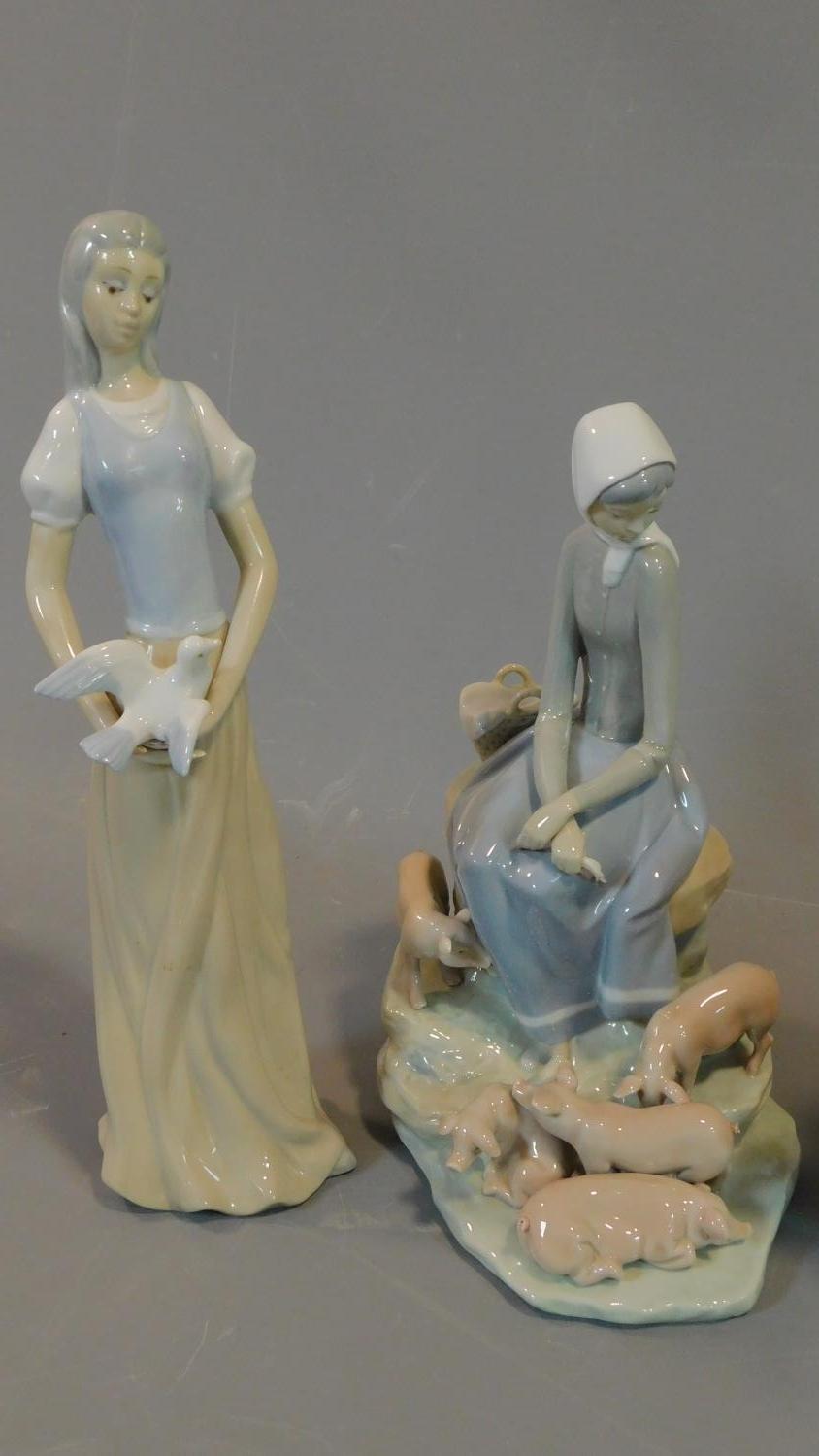 Seven figures by Lladro, Tengra and Nao: Lady holding a dove, milkmaid with pigs, girl holding a - Image 5 of 11