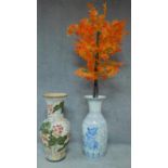 Two large oriental ceramic vases. One with lotus flower decoration and the other with birds and