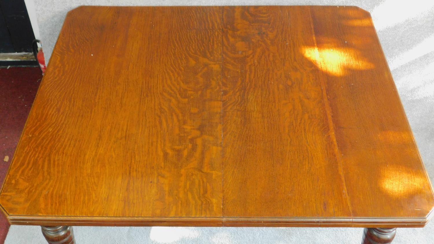 A late Victorian oak extending dining table with four extra leaves on turned tapering supports. H.75 - Image 2 of 6