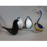 Four art glass birds, a pair of penguins, a pelican and a song bird. Tallest 28cm.