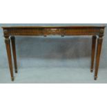 An Adam style mahogany console table on square tapering fluted supports. H.84 W.151 D.45cm