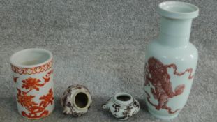 Two 18th century Chinese copper red hand painted bird feeders, a 19th century copper red painted