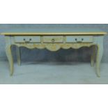 A blue and gilt decorated Louis XV style country side table fitted three frieze drawers on