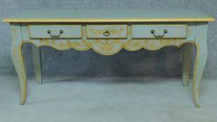 A blue and gilt decorated Louis XV style country side table fitted three frieze drawers on