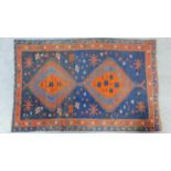 A Persian style rug with double pendant medallion set on sapphire field surrounded by geometric