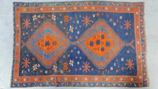 A Persian style rug with double pendant medallion set on sapphire field surrounded by geometric