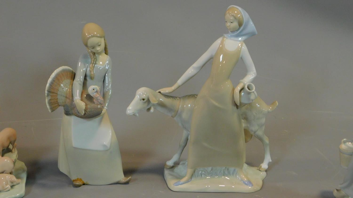 Seven figures by Lladro, Tengra and Nao: Lady holding a dove, milkmaid with pigs, girl holding a - Image 3 of 11