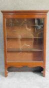 A 19th century mahogany glazed single door bookcase on shaped bracket feet. H.123 W.82 D.28cm