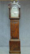 A 19th century oak cased longcase clock with painted arched dial. H.213cm