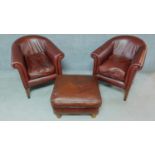 A pair of contemporary tan leather tub armchairs on square tapering supports together with a