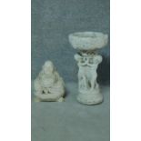 A painted concrete birdbath and seated buddah. Birdbath with three cherubs holding an urn. H.54 (