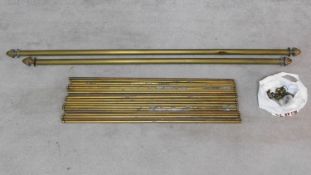 A set of nineteen brass stair rods together with two matching brass curtain poles. L.156 (longest)