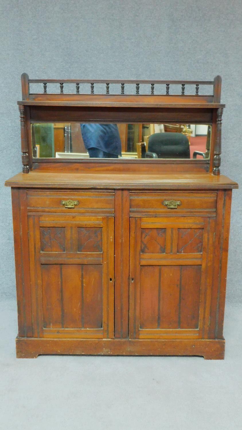 A late 19th century walnut two door chiffonier with mirrored superstructure. H.137 W.106 D.41cm