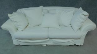 A contemporary two seater sofa in loose light cream covers by Mazzoti. H.80 W.215 D.93cm