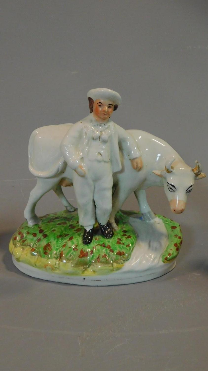 A collection of five early porcelain and earthenware figures, including a man with a bill, a - Image 4 of 8