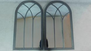 A pair of grey painted arched window pane mirrors. 139cm