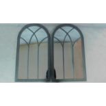 A pair of grey painted arched window pane mirrors. 139cm