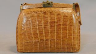 A vintage crocodile skin evening bag with brass swing, clip catch and tan suede interior with