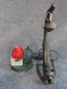 A vintage lamp in the form of a brick maker with red glass flame shade and marble base and modern