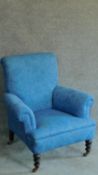 A Victorian mahogany framed armchair in blue floral upholstery. H.90cm
