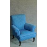 A Victorian mahogany framed armchair in blue floral upholstery. H.90cm