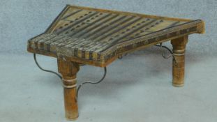 An antique Indian hardwood shaped top low table with brass studding and binding. H.38 W.87 D.64cm