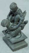 A Thai bronze statue of two Thai monkey gods fighting on a abstract design pedestal base.