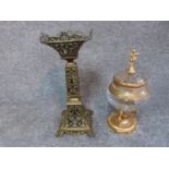 An antique pierced brass stand and cut glass and gilded metal sweet jar with finial in the form of a