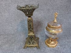 An antique pierced brass stand and cut glass and gilded metal sweet jar with finial in the form of a