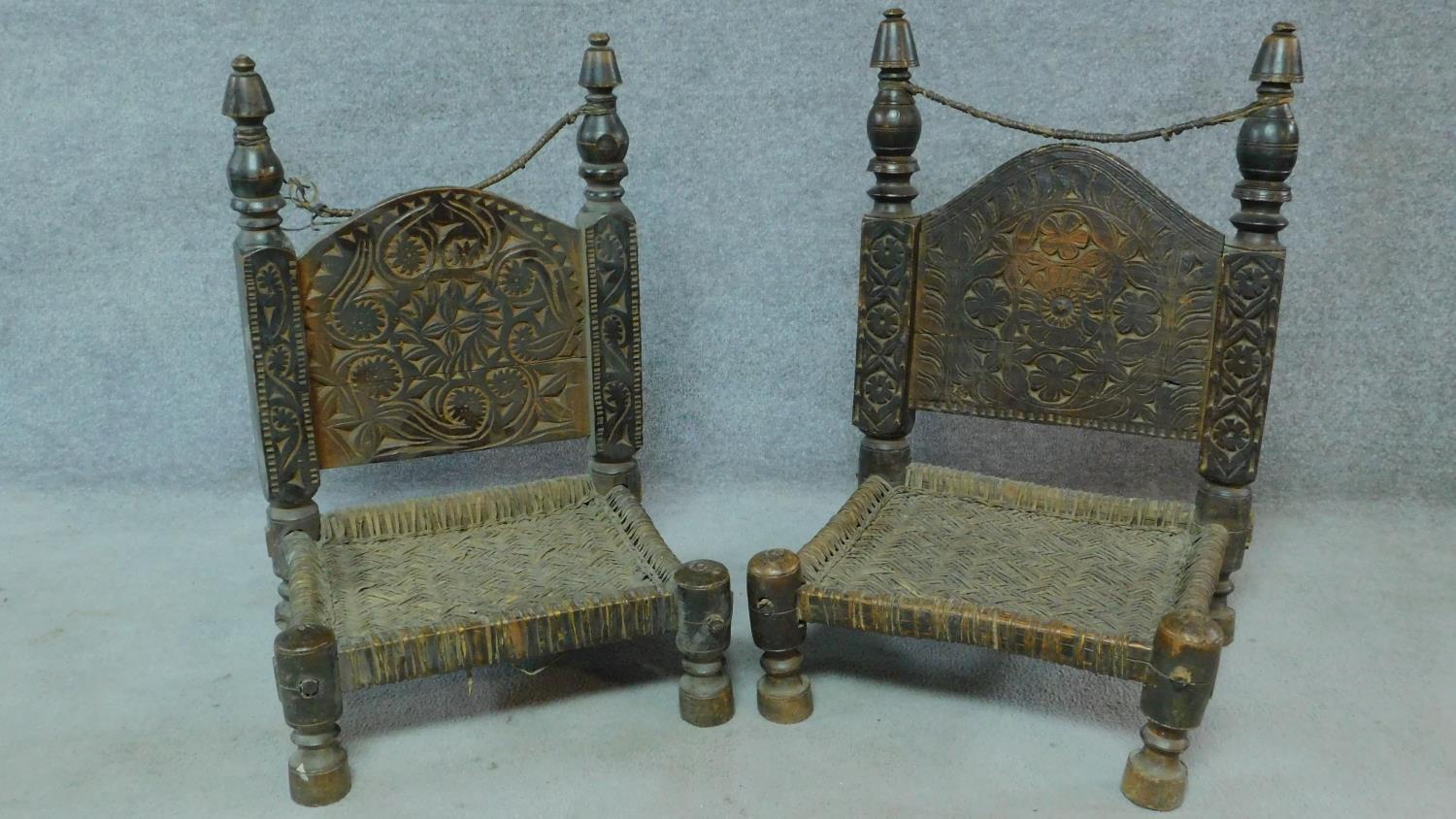 A pair of antique Afghanistan wedding praying stools with intricate allover carving. H.77cm