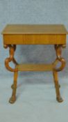 A 19th century Continental satin birch lamp table on carved paw feet. H.69 W.56 D.37cm