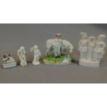 A collection of five early porcelain and earthenware figures, including a man with a bill, a