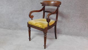 A Regency mahogany armchair with bar back and drop in seat on turned tapering supports. H.90cm