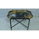 A Japanned metal butlers tray on faux bamboo base. H.48 W.71 D.51cm (some lacquer flaking)