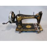An antique Singer sewing machine with Sphinx", or "Memphis" gold foil motifs. H27 x L46