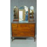 An Edwardian mahogany dressing table with triple mirror back. H.150 W.101 D.46cm (central mirror