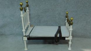 A Victorian brass and iron framed doll's bed. H.89 W.89 D.50cm