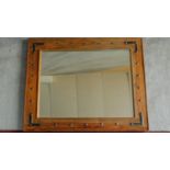 A medieval style metal bound wall mirror. 102x82cm