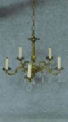 A gilt metal five branch chandelier with crystal drops. H.44 W.53cm