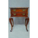 A Georgian style teak two drawer bedside chest on carved cabriole supports. H.68 W.53 D.37cm