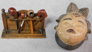 A tribal African Punu Female Okau figure mask and a collection of four Vintage wooden and plastic