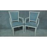 A pair of French style white painted open armchairs. H.93cm