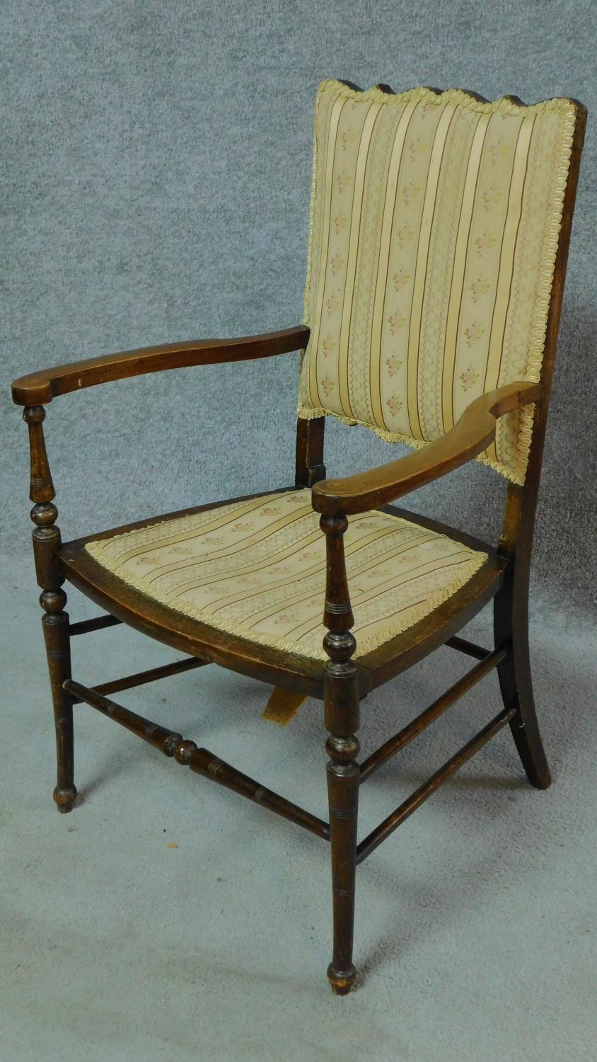 An Edwardian stained beech open armchair. H.86cm