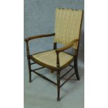 An Edwardian stained beech open armchair. H.86cm