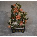 A Chinese carved jade and agate ornamental blossom tree with carved petals and leaves, in