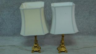 A pair of Rococo style gilt table lamps. H.63cm