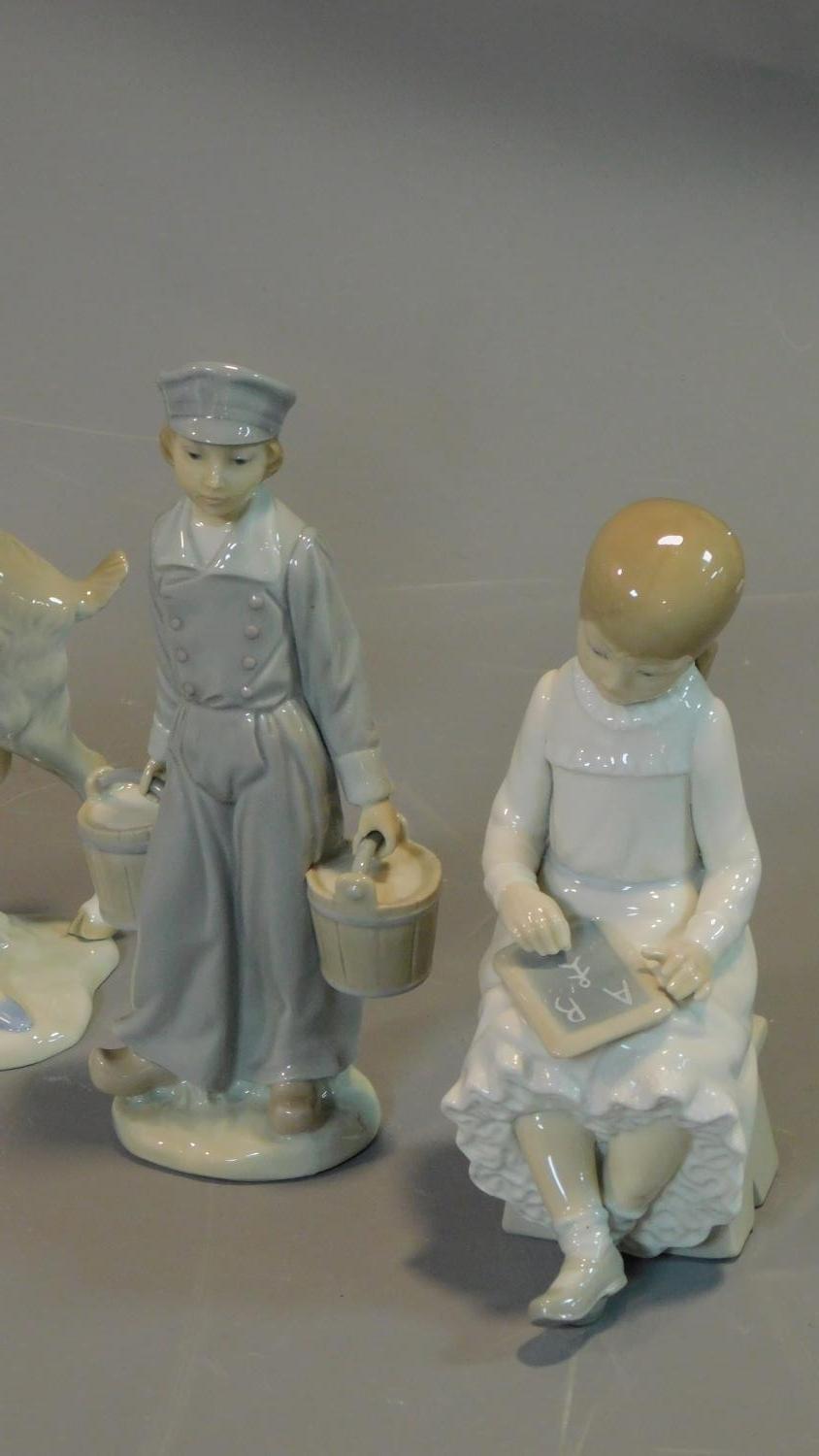 Seven figures by Lladro, Tengra and Nao: Lady holding a dove, milkmaid with pigs, girl holding a - Image 2 of 11